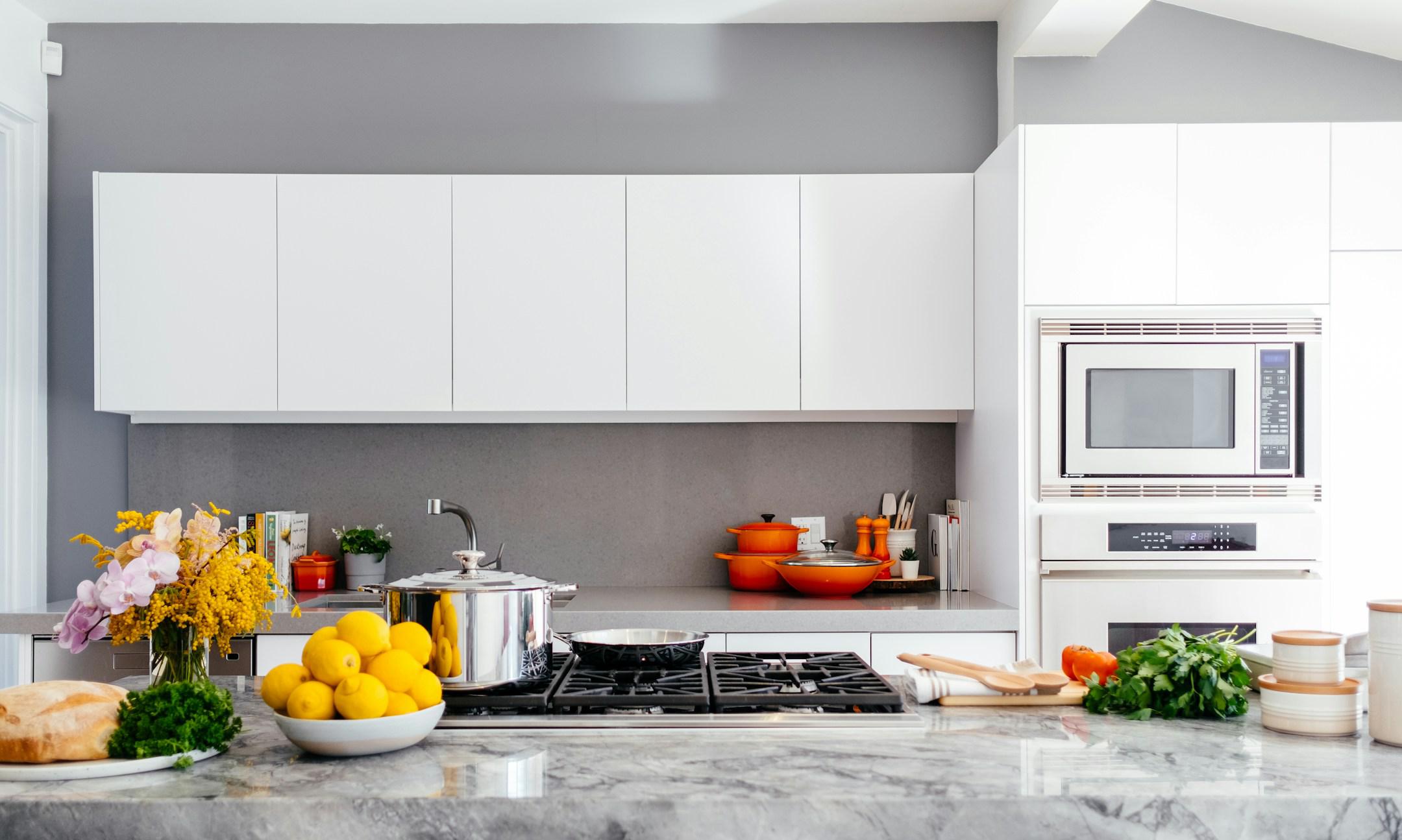 Kitchen with cooking equipment, utensils and built-in ovens